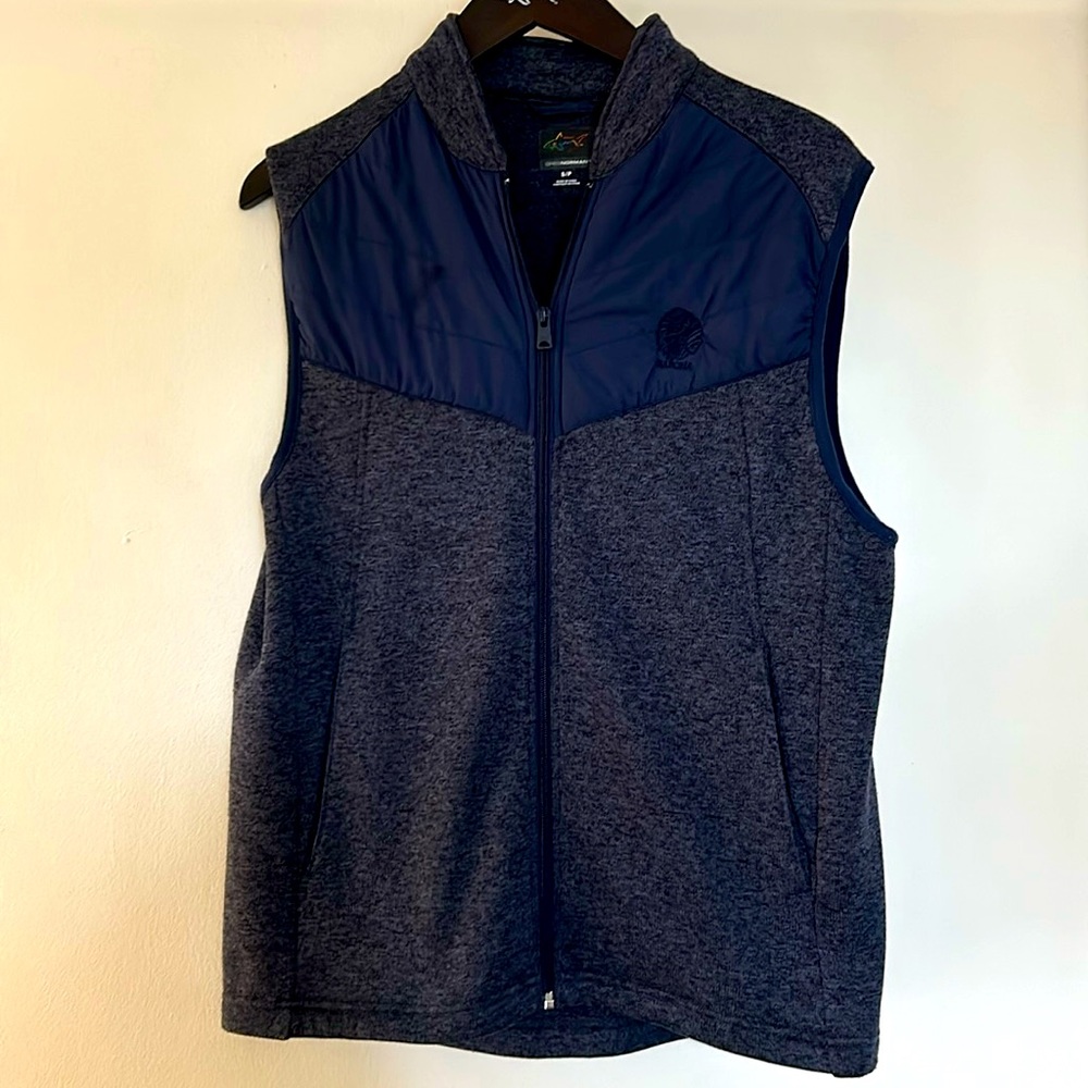 Blue Greg Norman vest with golf logo.